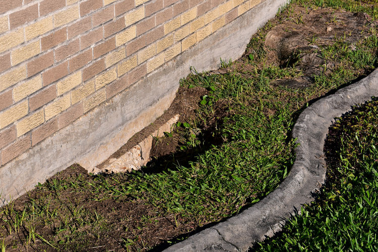 A hole in the foundation caused by water erosion